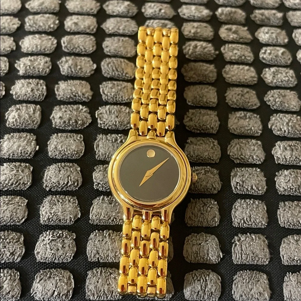 Movado black dial, gold tone bracelet strap watch